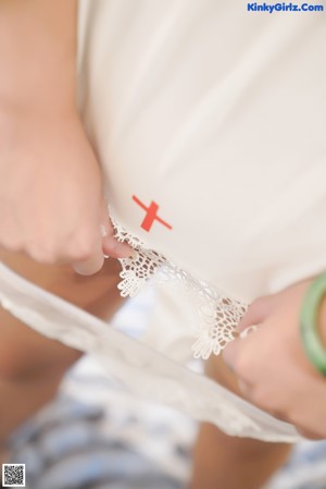 A close up of a woman wearing a white lingerie.
