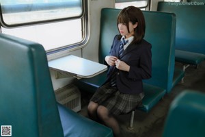 A woman in black stockings is sitting on a train.