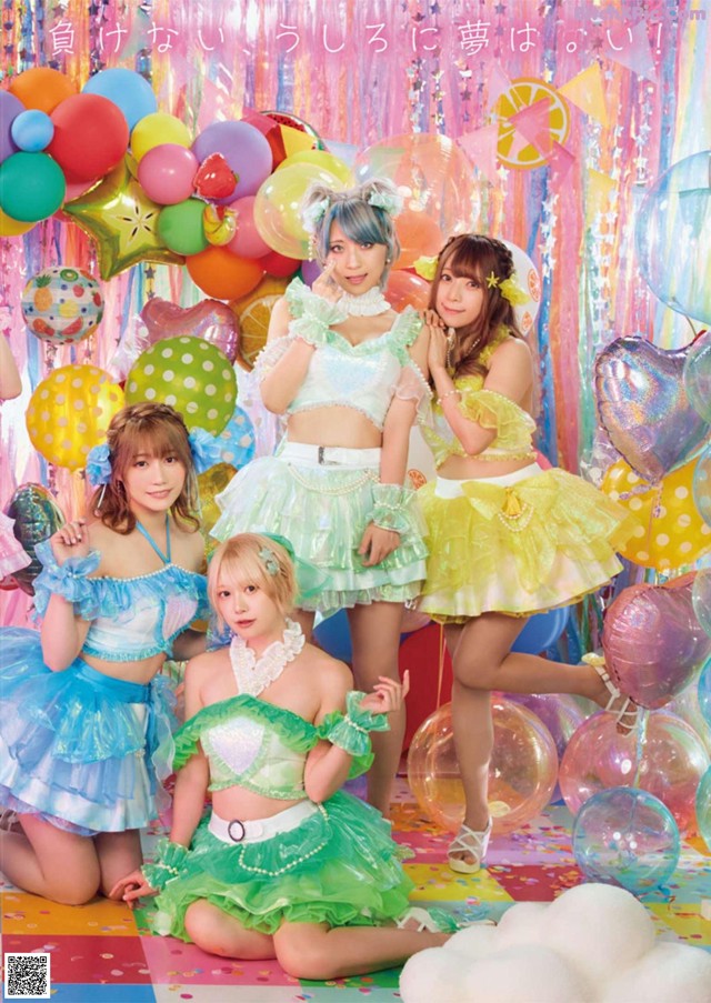 A group of girls in colorful outfits posing for a picture.