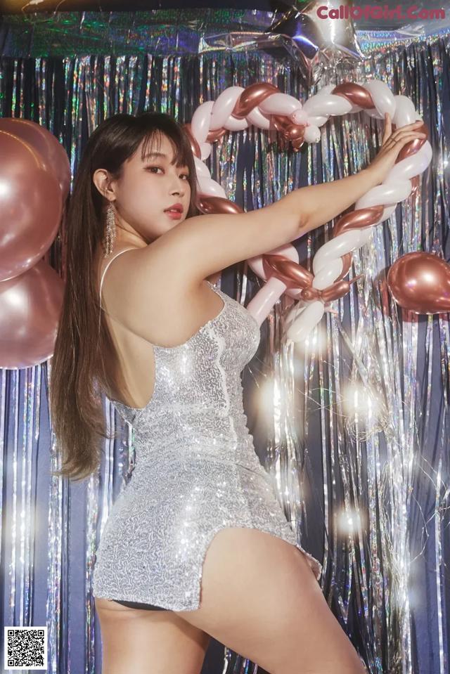 a woman in a silver dress posing for a picture