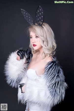 A woman in a bunny costume posing for a picture.