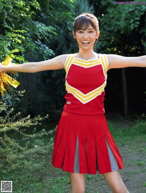 A woman in a blue and purple dress posing for a picture.