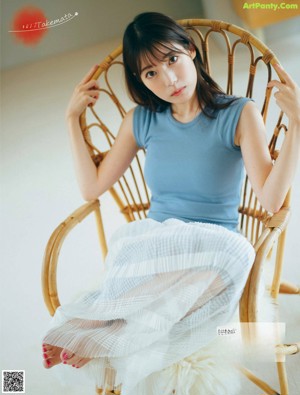 A woman in a pink sweater is looking away from the camera.