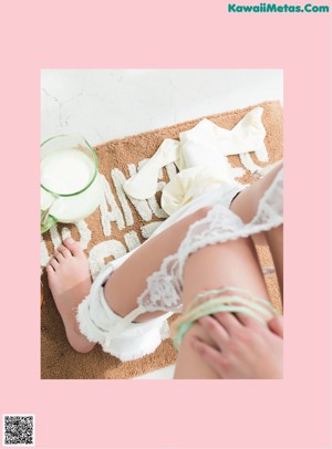 A woman in a bikini holding a glass of milk.