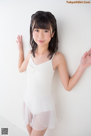 A woman in a white bodysuit standing on a scale.